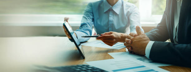IT consultants reviewing data on a tablet